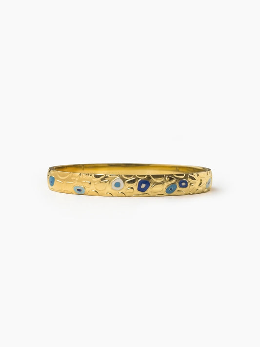 Gold bangle with blue enamel evil-eye detailing, Aveline Bangle by Sparkle Studio.