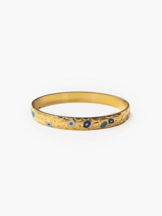 Gold bangle with blue enamel evil-eye detailing, Aveline Bangle by Sparkle Studio.